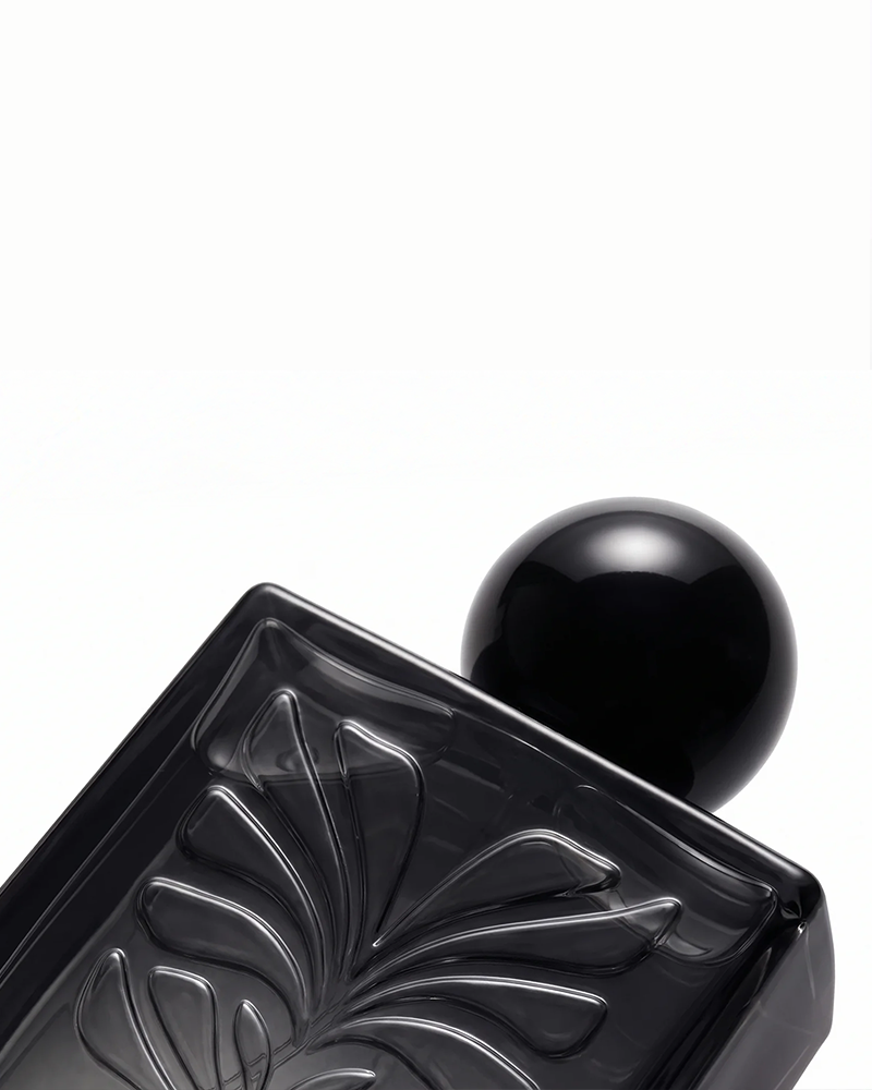 Close-up of FRAVE dark interior perfume bottle