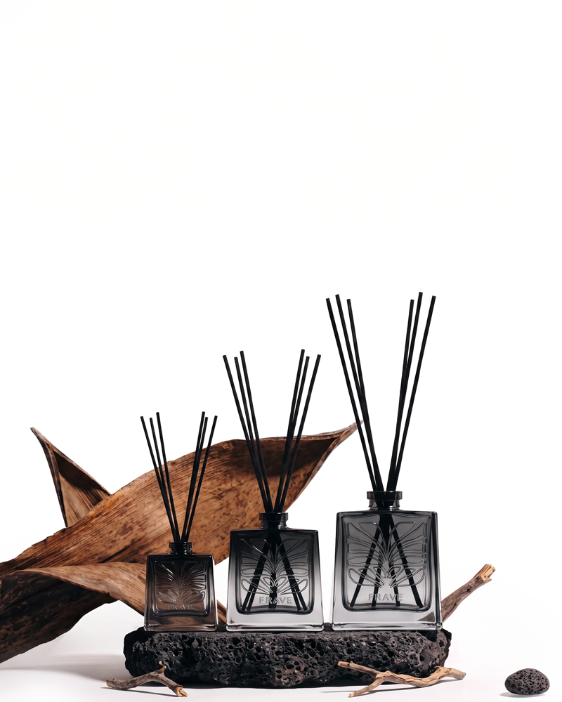 Three FRAVE reed diffusers styled with wood and volcanic stone